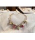 Bracciale in acciaio color oro con charms